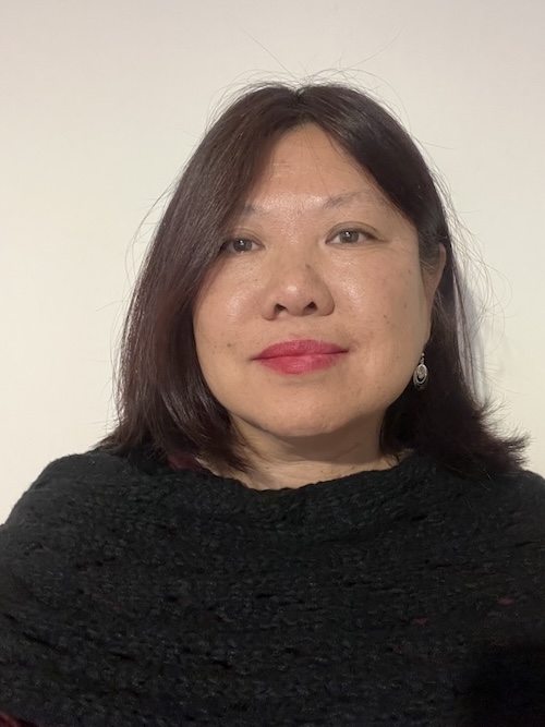 Headshot of a woman in a black sweater against a neutral backdrop